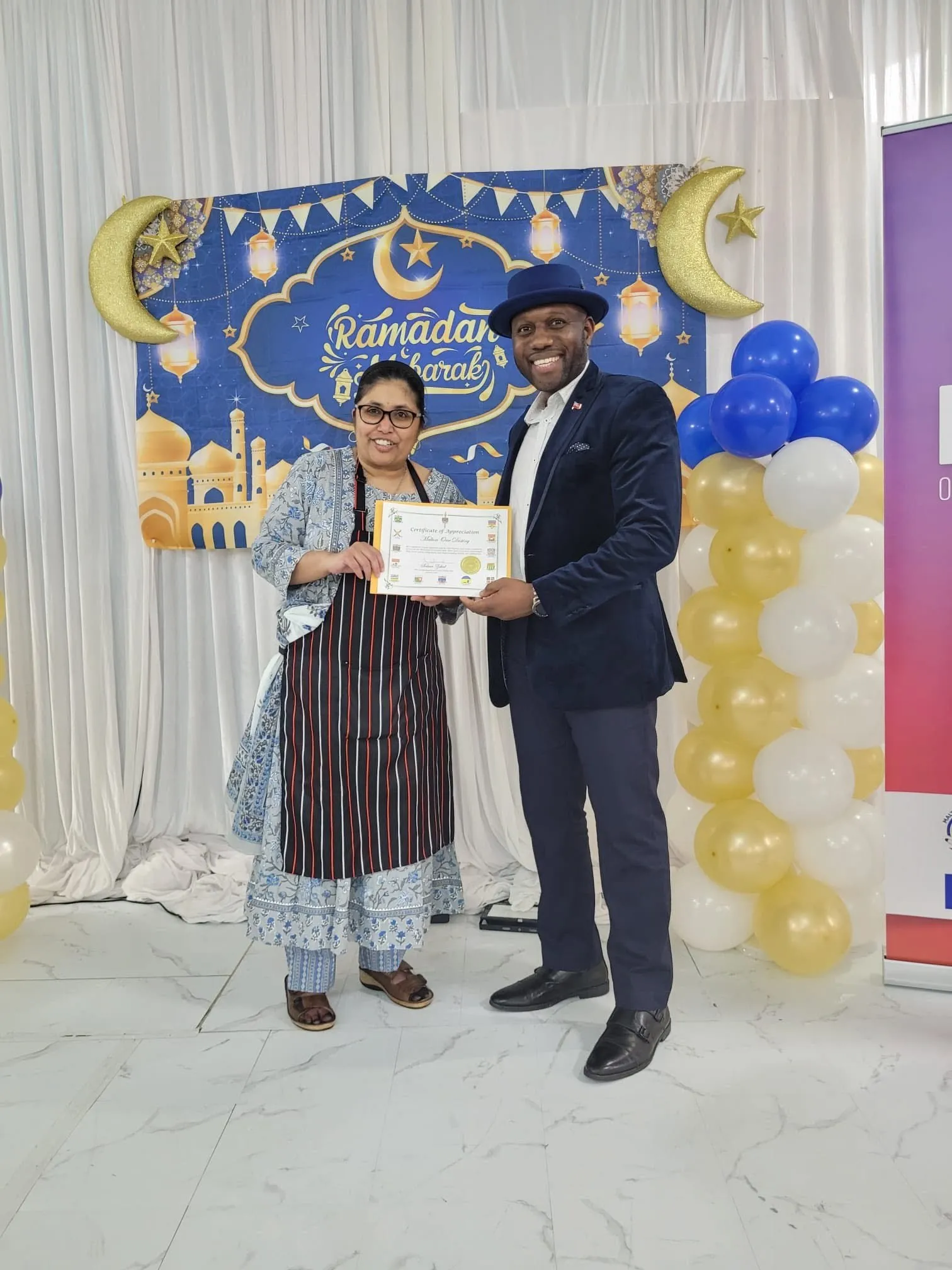 A guest receiving a certificate of appreciation at the Ramadan interfaith dinner, a One Love Gala
