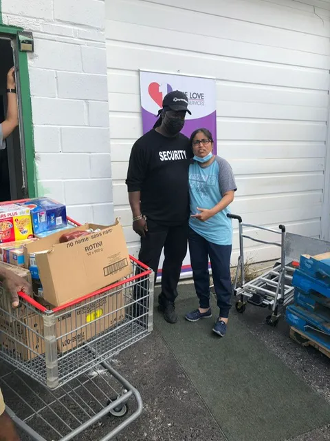 Volunteers with a cart of boxed groceries ready for families